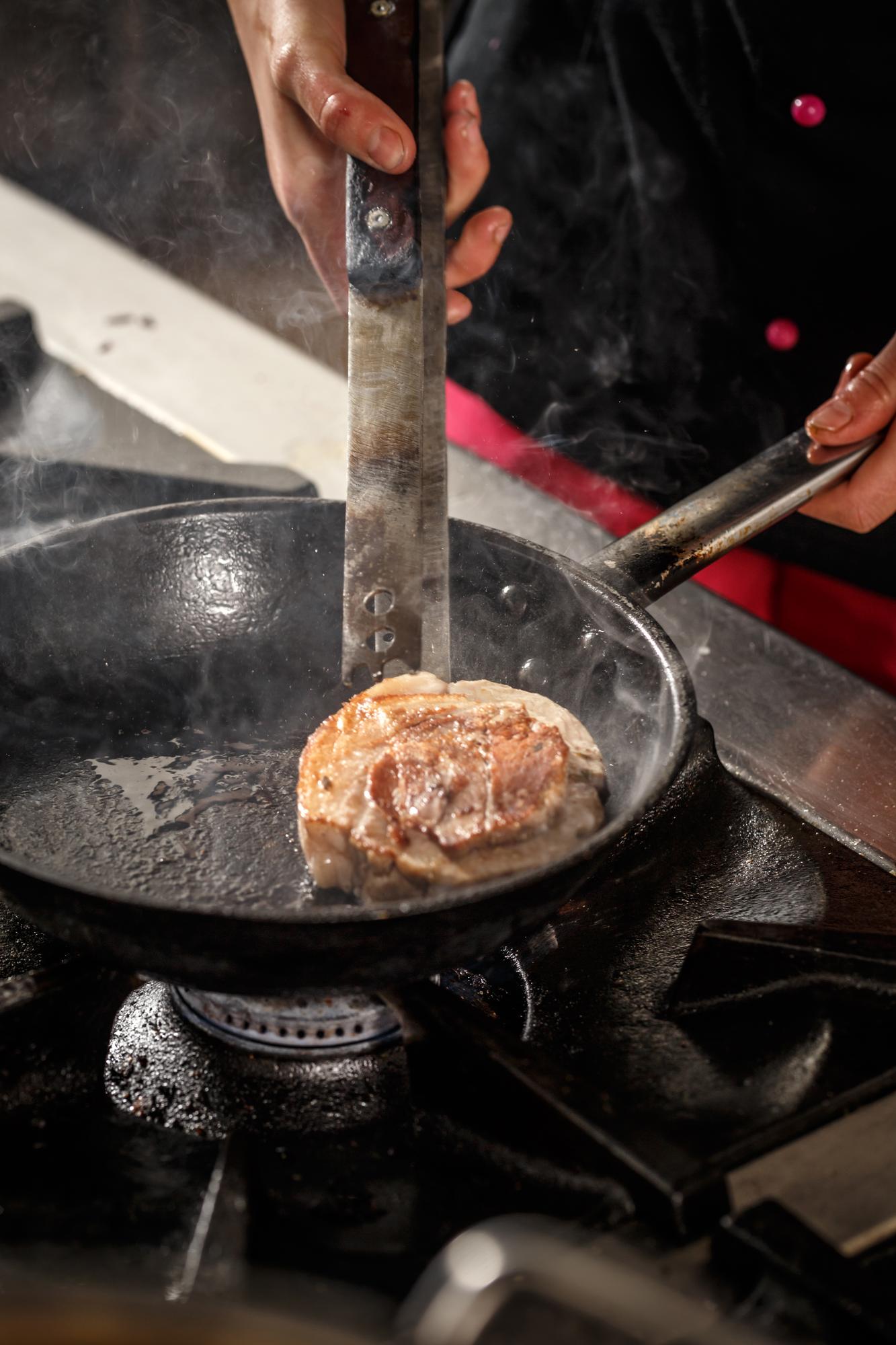 Action shot: searing meat on pan